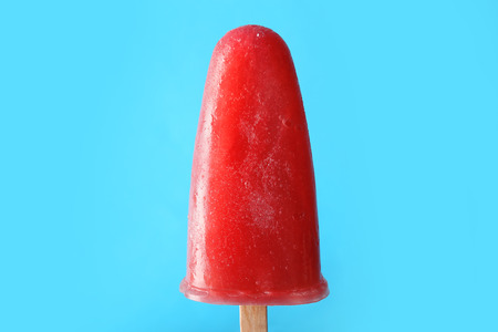 Delicious strawberry ice-cream on stick on color backgroundの写真素材