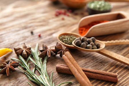 Composition with different spices on wooden backgroundの写真素材