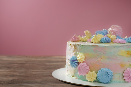 Beautiful tasty birthday cake on wooden tableの写真素材