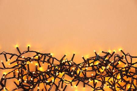 Festive Christmas garland on color background