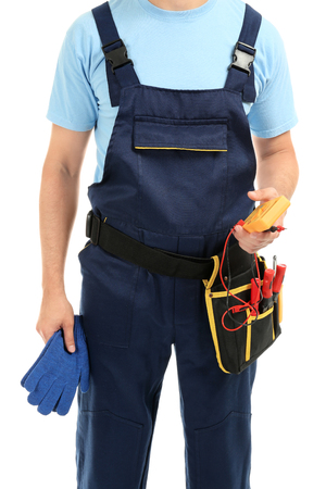 Electrician with multimeter and tools on white backgroundの写真素材