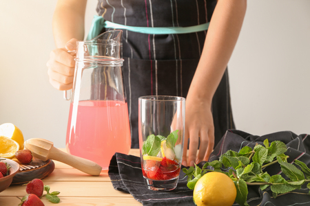 Woman preparing tasty strawberry lemonadeの写真素材
