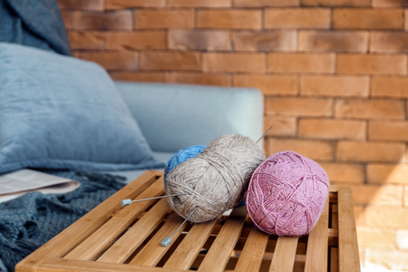 Colorful knitting yarn on wooden crate in roomの写真素材