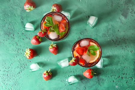 Tasty natural lemonade with strawberries in glasses on tableの写真素材