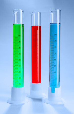 Graduated cylinders with different liquids on light backgroundの写真素材