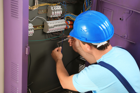 Electrician repairing distribution boardの写真素材
