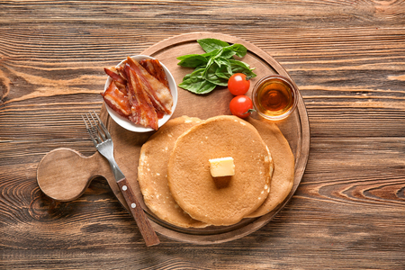 Composition with tasty pancakes and bacon on wooden tableの写真素材