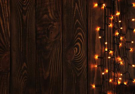 Beautiful bright Christmas garland on wooden backgroundの写真素材