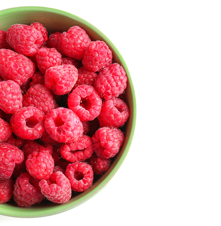 Bowl with ripe raspberries on white backgroundの写真素材