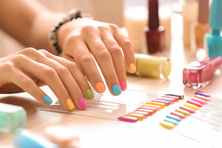 Young woman with colorful manicure in beauty salonの写真素材