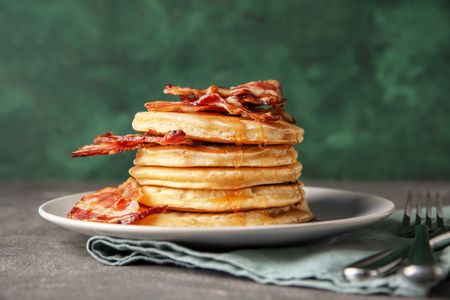 Tasty pancakes with fried bacon on plateの写真素材
