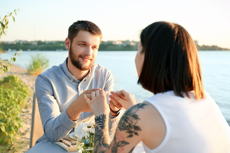 Happy lovely couple on date near riverの写真素材