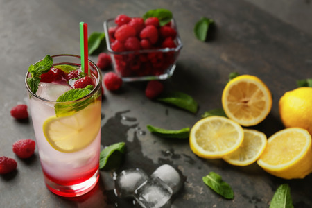 Glass of fresh raspberry mojito on tableの写真素材