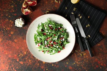 Plate with delicious healthy fresh salad on tableの写真素材