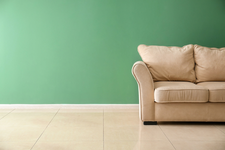 Comfortable sofa near color wallの写真素材