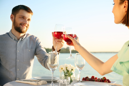 Happy lovely couple on date near riverの写真素材