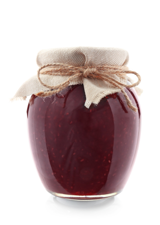 Glass jar with raspberry jam on white backgroundの写真素材