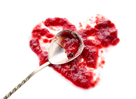 Sweet raspberry jam and spoon on white backgroundの写真素材