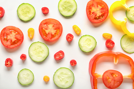 Different sliced vegetables on white backgroundの写真素材