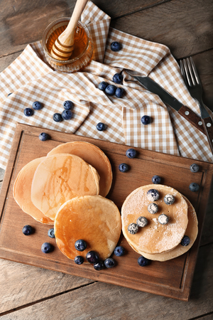 Composition with delicious pancakes on wooden tableの写真素材