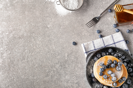 Delicious pancakes with berries on light tableの写真素材