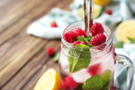 Mason jar of fresh raspberry mojito on wooden table, closeupの写真素材