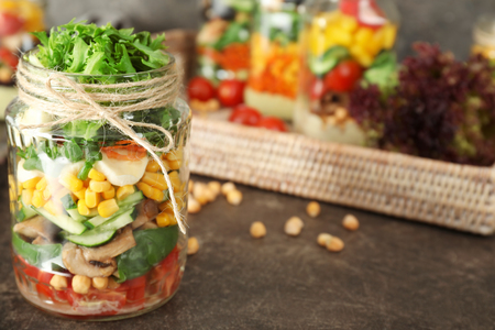 Delicious vegetable salad in mason jar on tableの写真素材