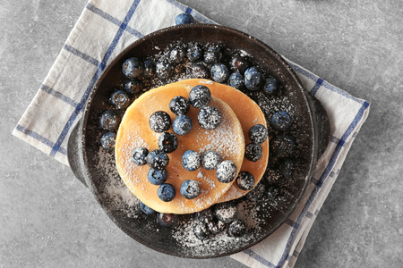 Delicious pancakes with berries on light tableの写真素材