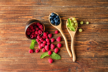 Various ripe berries on wooden background, top viewの写真素材