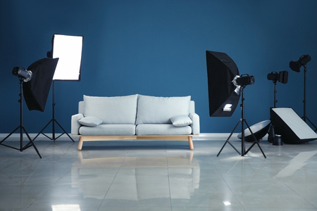 Interior of modern photo studio with professional equipment and sofaの写真素材