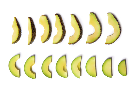 Slices of avocado on white backgroundの写真素材