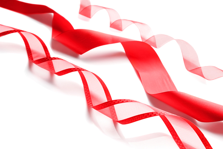 Red ribbons on white backgroundの写真素材