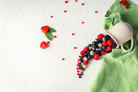 Composition with delicious ripe berries on light backgroundの写真素材