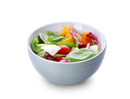Bowl with fresh vegetable salad on white backgroundの写真素材