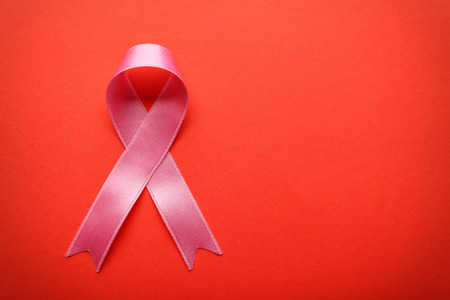 Pink ribbon on color background. Breast cancer awareness conceptの写真素材