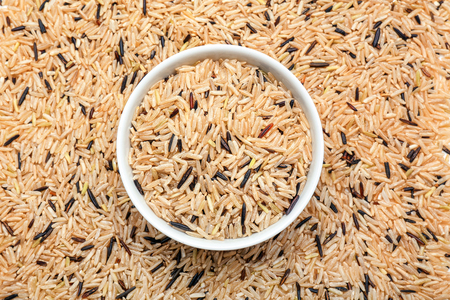 Bowl on unpolished riceの写真素材