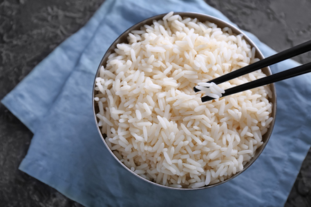 Eating of tasty boiled rice with chopsticks, closeupの写真素材