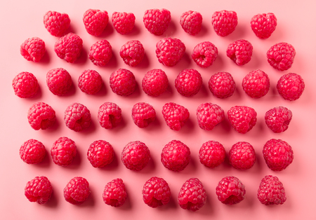 Composition with fresh ripe raspberries on color backgroundの写真素材
