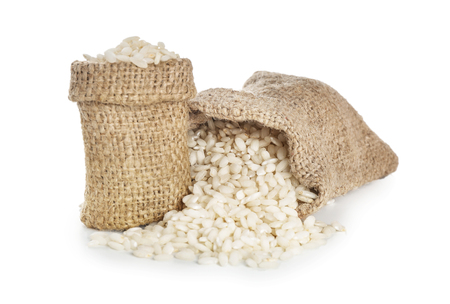 Bags with white rice on white backgroundの写真素材