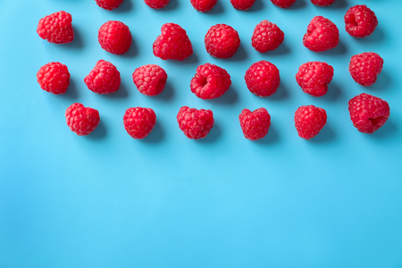 Fresh ripe raspberries on color background, flat layの写真素材
