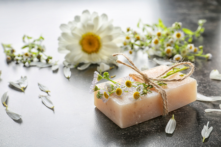 Natural homemade soap with chamomile flowers on tableの写真素材