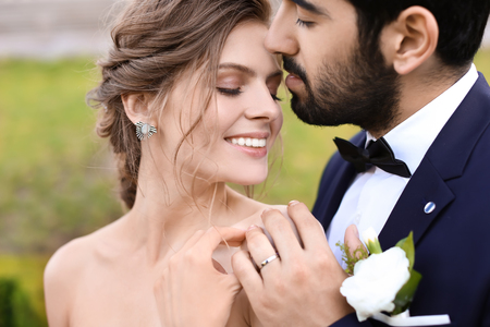 Happy young bride with her groom outdoorsの写真素材