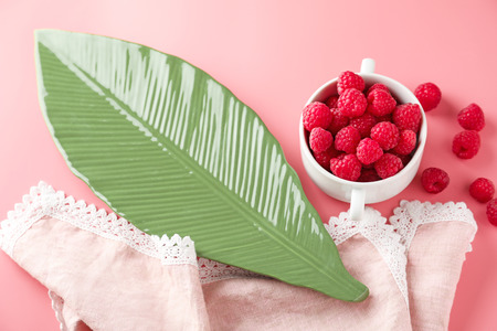 Composition with fresh ripe raspberries on color background