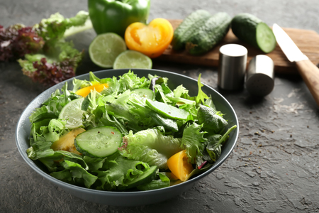 Plate with healthy vegetable salad on grunge tableの写真素材