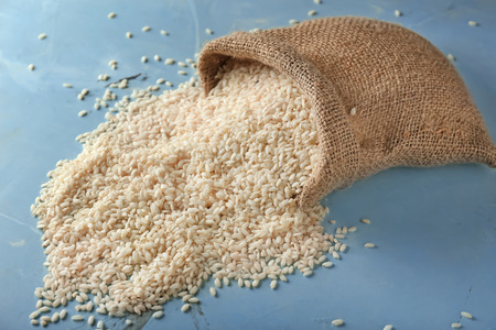 Sack with raw rice on tableの写真素材