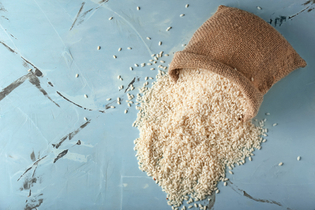 Sack with raw rice on table, top viewの写真素材