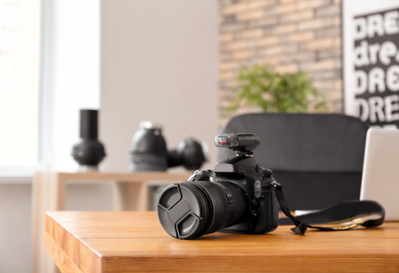 Professional camera on table in photo studio