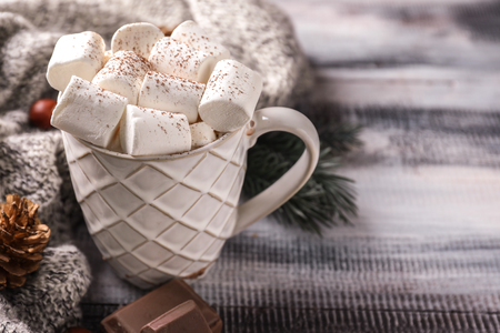 Cup of hot cocoa with marshmallows on wooden tableの写真素材
