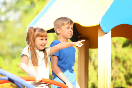 Cute little children outdoors on playgroundの写真素材