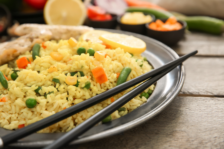 Tasty boiled rice with vegetables on plateの写真素材
